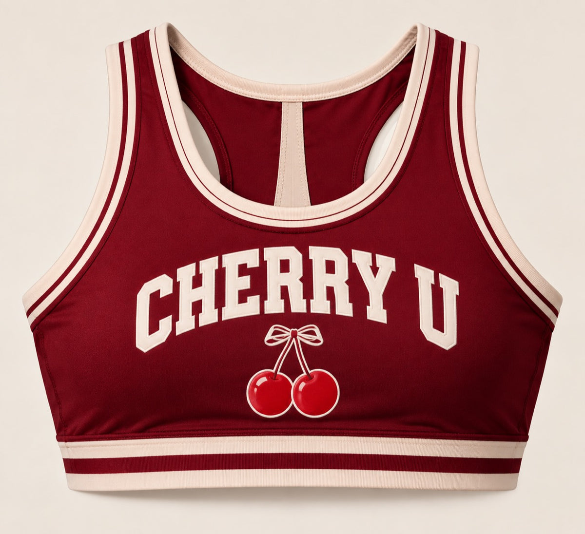 Maroon Cherry U cropped cheer shell with cream trim and cherry emblem