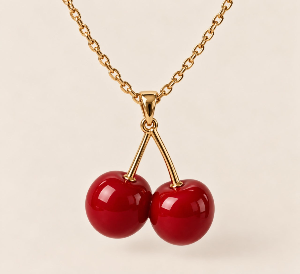 Gold necklace with glossy red double-cherry pendant