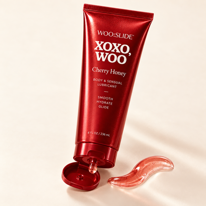 Open WOO:SLIDE Cherry Honey tube dispensing translucent pink lubricant