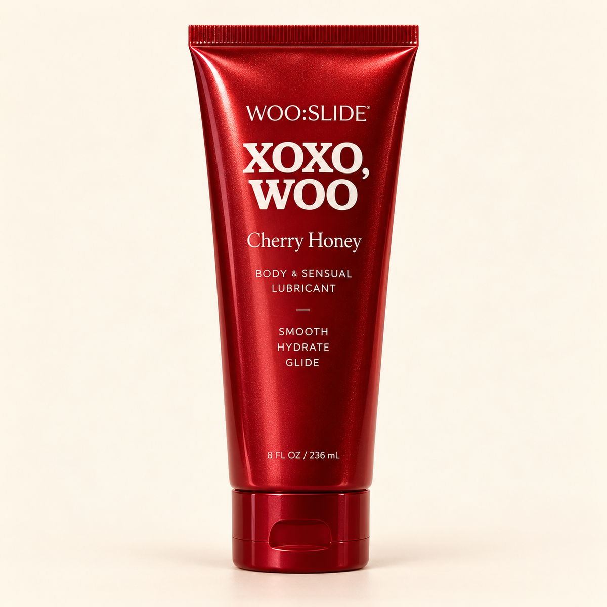 WOO:SLIDE Cherry Honey lubricant tube on a clean cream background